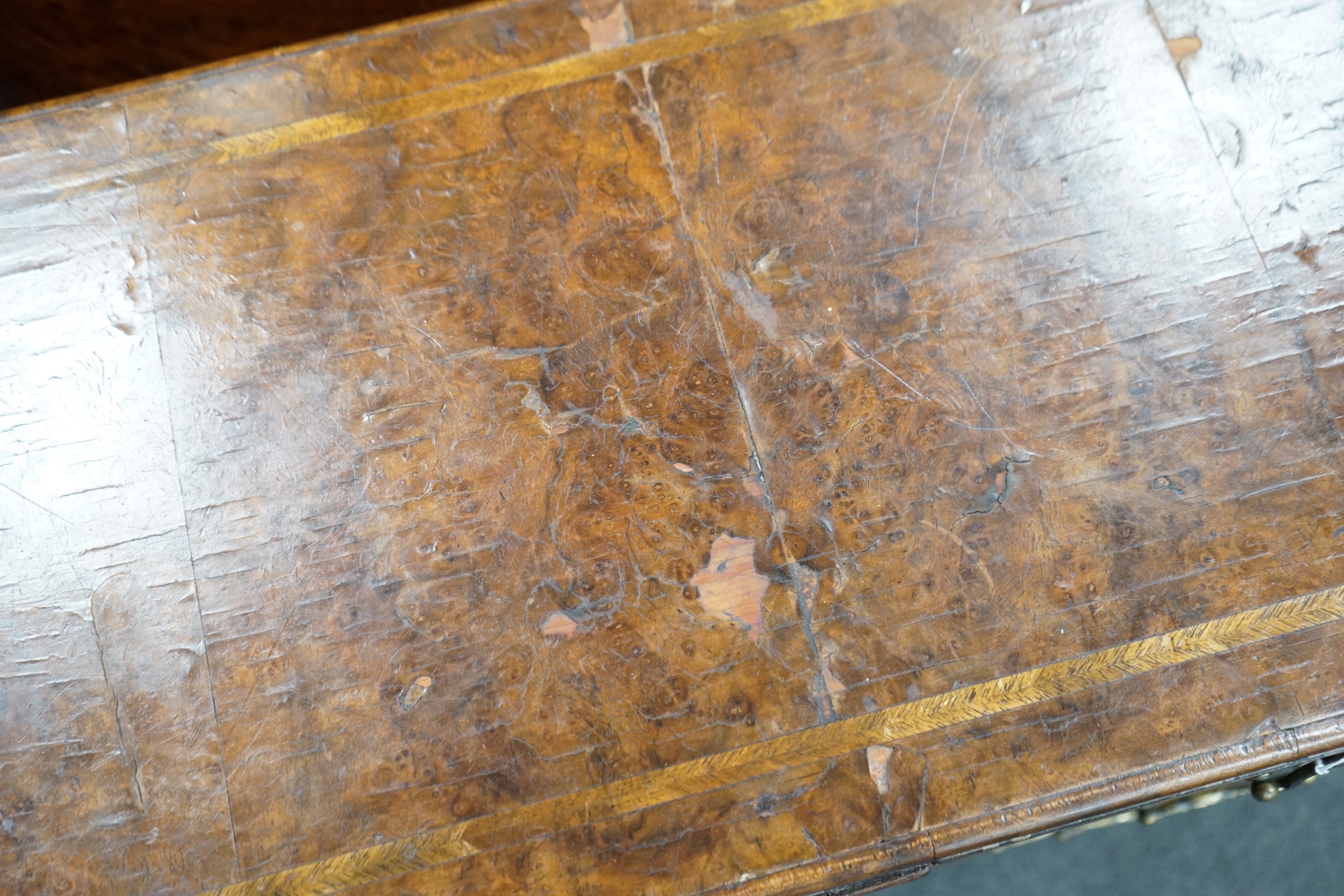 An early 18th century style feather banded walnut bachelor's chest, width 76cm, depth 34cm, height 75cm